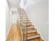 Staircase with hardwood steps, white risers, and a modern metal railing at 472 Martin Se St # 1, Atlanta, GA 30312