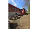 Image showing the brick and stone exterior with red trim and scattered debris in the yard at 1404 Aniwaka Sw Ave, Atlanta, GA 30311