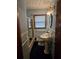 Cozy bathroom featuring a single pedestal sink, classic tiles, and a shower-tub combination at 1404 Aniwaka Sw Ave, Atlanta, GA 30311
