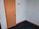 This bedroom features faded blue walls, dark carpet, and a simple door at 1404 Aniwaka Sw Ave, Atlanta, GA 30311