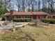 Charming single-story home with brick exterior, pink shutters, and mature landscaping at 1404 Aniwaka Sw Ave, Atlanta, GA 30311