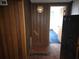 View of a wood-paneled hallway with a view into a brightly lit room at 1404 Aniwaka Sw Ave, Atlanta, GA 30311