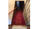 Stairway with red carpet and wood paneling at 1404 Aniwaka Sw Ave, Atlanta, GA 30311
