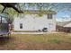 Large backyard with white vinyl siding, a concrete patio, and a trampoline, perfect for Gathering fun at 2172 Creekview Trl, Decatur, GA 30035