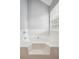 Bright bathroom featuring a soaking tub beneath a window with white tile surround at 2172 Creekview Trl, Decatur, GA 30035