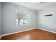 Bedroom featuring neutral walls, vinyl wood flooring, and a window at 2172 Creekview Trl, Decatur, GA 30035