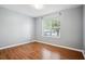 Bedroom featuring neutral walls, vinyl wood flooring, and a window at 2172 Creekview Trl, Decatur, GA 30035