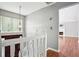 Open view from staircase to entryway, with pendant light, front door and view of fireplace in the living room at 2172 Creekview Trl, Decatur, GA 30035