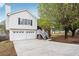 Charming home featuring a two-car garage and a cozy front porch with stairs leading to the entrance at 2172 Creekview Trl, Decatur, GA 30035