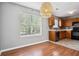 Open eat-in kitchen area featuring updated appliances, stone backsplash, and hardwood floors at 2172 Creekview Trl, Decatur, GA 30035