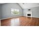 Spacious living room features laminate floors, a fireplace, and ample natural light from large windows at 2172 Creekview Trl, Decatur, GA 30035