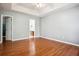 Large main bedroom featuring hardwood floors, ceiling fan and views to ensuite bathroom and walk-in closet at 2172 Creekview Trl, Decatur, GA 30035
