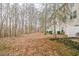 Vast backyard with leafless trees, a patio, and green trash cans offering a private outdoor space at 3302 Waldrop Trl, Decatur, GA 30034