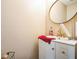 A clean bathroom with a white sink vanity, modern fixtures, and a round mirror at 3302 Waldrop Trl, Decatur, GA 30034