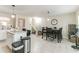 Open-concept dining area featuring tile floors, modern pendant lighting, and adjacent kitchen island with seating at 3302 Waldrop Trl, Decatur, GA 30034