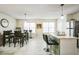 Bright dining area featuring tile floors, a large clock, modern lighting and seating for six at 3302 Waldrop Trl, Decatur, GA 30034