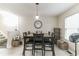 Dining area with tile floors, large wall clock, dining table set for six, and decorative shelving at 3302 Waldrop Trl, Decatur, GA 30034
