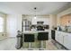 Kitchen featuring white cabinets, stainless steel appliances, and a center island with bar stool seating at 3302 Waldrop Trl, Decatur, GA 30034