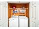 Functional laundry closet with white washer and dryer and plenty of storage space on shelves at 3302 Waldrop Trl, Decatur, GA 30034