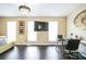 Bright living room with large windows, dark wood floors, and modern lighting fixtures at 3302 Waldrop Trl, Decatur, GA 30034