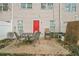 A cozy patio area for outdoor dining, complete with table, chairs, and a bright red door at 3302 Waldrop Trl, Decatur, GA 30034