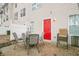 An outdoor patio area with neutral furniture and a pop of color from the red backdoor at 3302 Waldrop Trl, Decatur, GA 30034