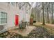 Relaxing patio area with table, chairs, grill, and red back door for easy access to the outside at 3302 Waldrop Trl, Decatur, GA 30034