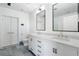 Bright bathroom showcasing a double sink vanity with white marble countertops, modern fixtures, and stylish gray flooring at 1080 Peachtree Ne St # 1610, Atlanta, GA 30309