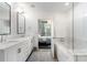 Open ensuite bathroom with double vanity and a soaking tub, connecting to a bedroom with city view at 1080 Peachtree Ne St # 1610, Atlanta, GA 30309