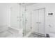 Bathroom featuring a glass shower with subway tile surround and built-in bench next to linen closet at 1080 Peachtree Ne St # 1610, Atlanta, GA 30309