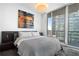 Bedroom featuring modern decor and large windows with city views at 1080 Peachtree Ne St # 1610, Atlanta, GA 30309