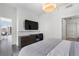 Modern bedroom featuring a sleek desk, media center, and beautiful city views through the windows at 1080 Peachtree Ne St # 1610, Atlanta, GA 30309