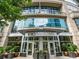 Upscale building entrance featuring a modern facade, lush landscaping, and prominent signage for 1010 Midtown at 1080 Peachtree Ne St # 1610, Atlanta, GA 30309