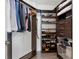 Walk-in closet with custom wood shelving, hanging rods, drawers, and ample storage space at 1080 Peachtree Ne St # 1610, Atlanta, GA 30309