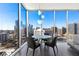 Bright dining space with floor-to-ceiling windows and amazing city views, featuring modern table and chairs at 1080 Peachtree Ne St # 1610, Atlanta, GA 30309