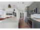 Updated kitchen with gray cabinets, stainless appliances, a quartz countertop island, and modern fixtures at 1080 Peachtree Ne St # 1610, Atlanta, GA 30309