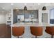 Sleek kitchen with a marble countertop island, gray cabinets, modern stainless steel appliances, and designer pendant lighting at 1080 Peachtree Ne St # 1610, Atlanta, GA 30309