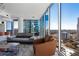 Bright living space with floor-to-ceiling windows offering stunning cityscape views, a modern sofa and arm chair at 1080 Peachtree Ne St # 1610, Atlanta, GA 30309