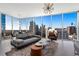 Bright living room featuring floor to ceiling windows with expansive city views, modern furniture, and stylish lighting at 1080 Peachtree Ne St # 1610, Atlanta, GA 30309