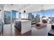 Open-concept living area with city skyline views through large windows and hardwood flooring at 1080 Peachtree Ne St # 1610, Atlanta, GA 30309