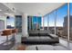 Modern living room with large windows, a comfortable sofa, and sleek, contemporary design with city views at 1080 Peachtree Ne St # 1610, Atlanta, GA 30309
