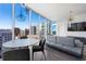 Bright living room with floor-to-ceiling windows offering great city views, dining area, and modern sofa at 1080 Peachtree Ne St # 1610, Atlanta, GA 30309