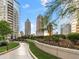 Beautifully landscaped walkway in a community with high-rise buildings in the background at 1080 Peachtree Ne St # 1610, Atlanta, GA 30309