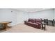 Finished basement with seating area including a leather sofa and side tables at 1775 Unity Loop, Cumming, GA 30040