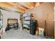 Unfinished basement with exposed beams and organized storage and work area at 1775 Unity Loop, Cumming, GA 30040