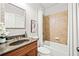 Cozy bathroom featuring granite countertop, framed mirror, and a shower over tub with tile surround at 1775 Unity Loop, Cumming, GA 30040