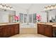 Bright bathroom featuring a large soaking tub, dual vanities, and tile floors at 1775 Unity Loop, Cumming, GA 30040