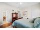 Bright bedroom featuring a decorative armoire, wood floors, and a ceiling fan at 1775 Unity Loop, Cumming, GA 30040