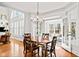 Sunlit breakfast nook with hardwood floors, french doors, and large windows offering views of the back yard at 1775 Unity Loop, Cumming, GA 30040