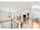 Bright hallway with hardwood floors, staircase with white railing and a view of the Gathering room at 1775 Unity Loop, Cumming, GA 30040
